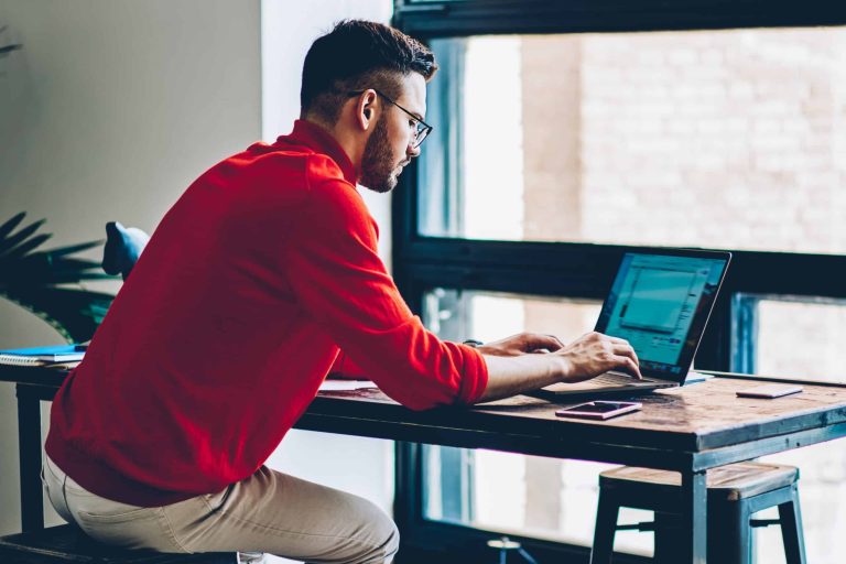 Young male it developer communicating with online customer service from provider